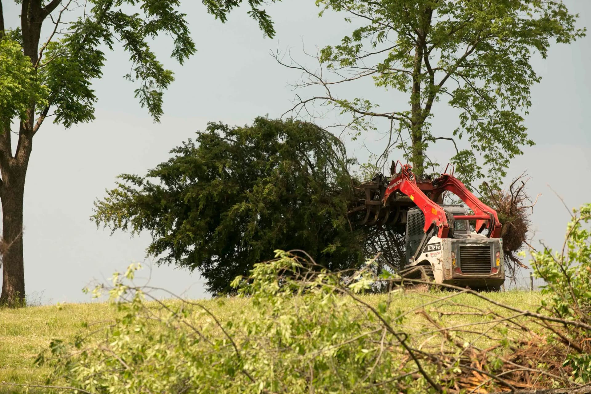 Modern red agricultural tractor working in the field